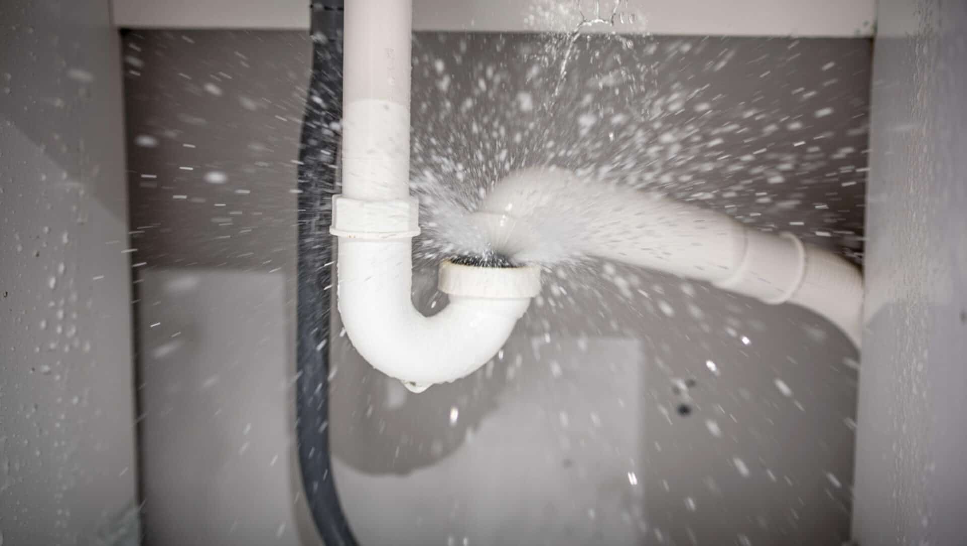 Water pipe bursting and spraying water causing a plumbing emergency